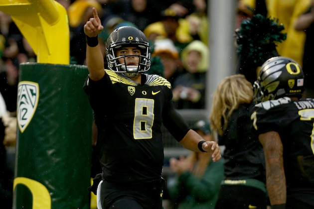 Oregon quarterback Marcus Mariota (8) points to the crowd after scoring a touchdown during the first quarter against Stanford in an NCAA college football game in Eugene, Ore., Saturday, Nov. 1, 2014. (AP Photo/Ryan Kang)