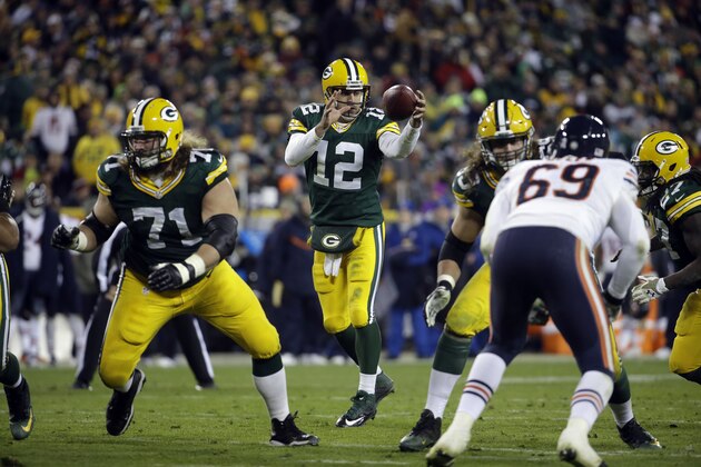 Green Bay Packers quarterback Aaron Rodgers (12) takes a snap during the second half of an NFL football game against the Chicago Bears Sunday, Nov. 9, 2014, in Green Bay, Wis. (AP Photo/Morry Gash)