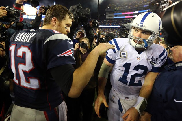 FOXBORO, MA - JANUARY 11:  (L-R) Tom Brady #12 of the New England Patriots talks with Andrew Luck #12 of the Indianapolis Colts after their AFC Divisional Playoff game at Gillette Stadium on January 11, 2014 in Foxboro, Massachusetts. The New England Patriots defeated the Indianapolis Colts 43 to 22.  (Photo by Al Bello/Getty Images)