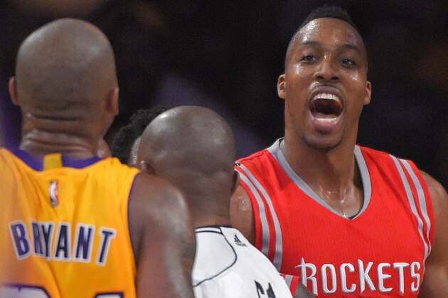 Houston Rockets center Dwight Howard, right, has words with Los Angeles Lakers guard Kobe Bryant during the second half of an NBA basketball game, Tuesday, Oct. 28, 2014, in Los Angeles.  The Rockets won 108-90. (AP Photo/Mark J. Terrill)