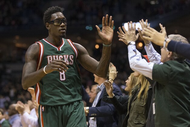 Milwaukee Bucks' Larry Sanders (8) high-fives fans after his team defeated the Philadelphia 76ers in an NBA basketball game Friday, Oct. 31, 2014, in Milwaukee. (AP Photo/Tom Lynn)