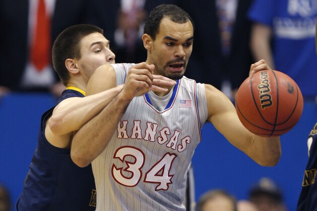 LAWRENCE, KS - FEBRUARY 8:  Perry Ellis #34 of the Kansas Jayhawks tries to grab a rebound but is fouled by Nathan Adrian #11 of the West Virginia Mountaineers in the second half at Allen Fieldhouse on February 8, 2014 in Lawrence, Kansas. (Photo by Ed Zurga/Getty Images)