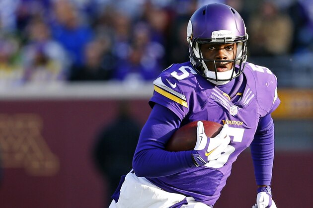 Minnesota Vikings quarterback Teddy Bridgewater (5) runs the ball against the Washington Redskins during an NFL football game, Sunday, Nov. 2, 2014, in Minneapolis. (Jeff Haynes/AP Images for Panini)