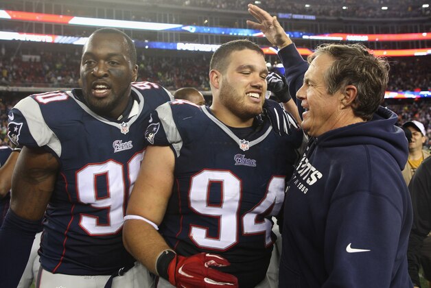 FOXBORO, MA - OCTOBER 16:  Chris Jones #94 of the New England Patriots is congratulated by head coach Bill Belichick after blocking a field goal attempt in the final seconds of the fourth quarter against the New York Jets Gillette Stadium on October 16, 2014 in Foxboro, Massachusetts.  (Photo by Jim Rogash/Getty Images)