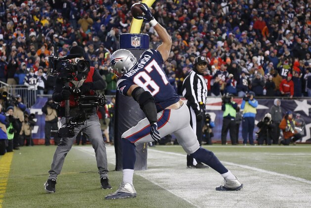 New England Patriots tight end Rob Gronkowski celebrates in the end zone after catching a touchdown pass from quarterback Tom Brady in the second half of an NFL football game against the Denver Broncos on Sunday, Nov. 2, 2014, in Foxborough, Mass. (AP Photo/Elise Amendola)