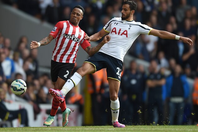 Tottenham Hotspur's Nacer Chadli, right, competes for the ball with Southampton's Nathaniel Clyne during their English Premier League soccer match at White Hart Lane, London, Sunday, Oct. 5, 2014. (AP Photo/Tim Ireland)