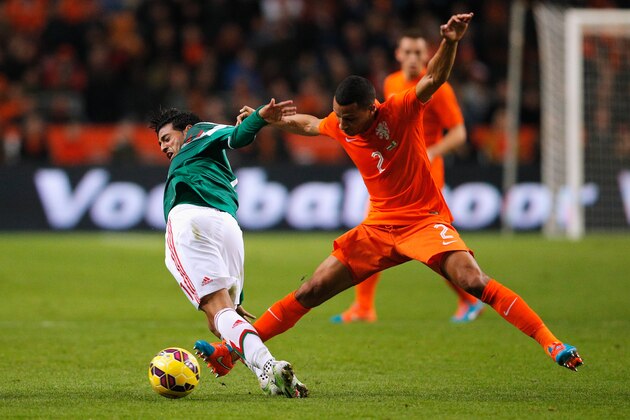 AMSTERDAM, NETHERLANDS - NOVEMBER 12:  Ricardo Van Rhijn of Netherlands and Carlos Vela of Mexico battle for the ball during the international friendly match between Netherlands and Mexico held at the Amsterdam ArenA on November 12, 2014 in Amsterdam, Netherlands.  (Photo by Dean Mouhtaropoulos/Getty Images)