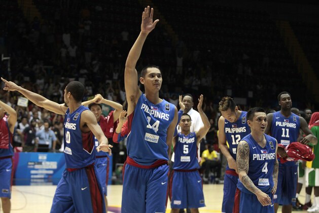 Japeth Aguilar of the Philippines, center, waves with teammates after winning the Group B Basketball World Cup match against Senegal in Seville, Spain, Thursday, Sept. 4, 2014. The 2014 Basketball World Cup competition will take place in various cities in Spain from Aug. 30 through to Sept. 14. (AP Photo/Miguel Angel Morenatti)