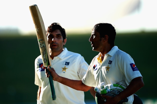 ABU DHABI, UNITED ARAB EMIRATES - NOVEMBER 10:  Younis Khan and Misbah-ul-Haq of Pakistan acknowledge the crowd as they leave the field after both reaching their centuries during day two of the first test between Pakistan and New Zealand at Sheikh Zayed stadium on November 10, 2014 in Abu Dhabi, United Arab Emirates.  (Photo by Warren Little/Getty Images)