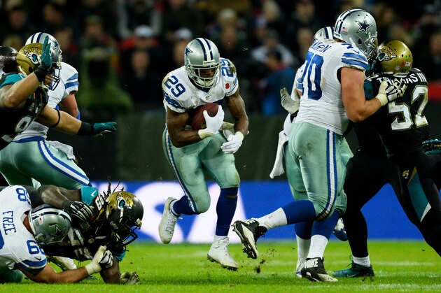 LONDON, ENGLAND - NOVEMBER 09:  DeMarco Murray #29 of the Dallas Cowboys bursts through a hole during the NFL week 10 match between the Jackson Jaguars and the Dallas Cowboys at Wembley Stadium on November 9, 2014 in London, England.  (Photo by Alan Crowhurst/Getty Images)
