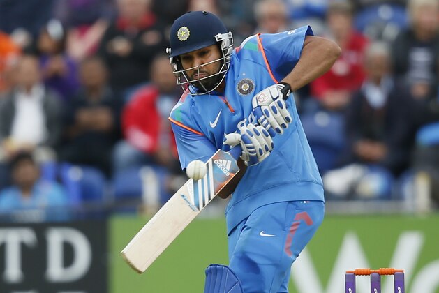 India's Rohit Sharma hits runs off the bowling of England's Chris Jordan during their One Day International cricket match at the SWALEC cricket ground in Cardiff, Wales, Wednesday, Aug. 27, 2014. (AP Photo/Alastair Grant)