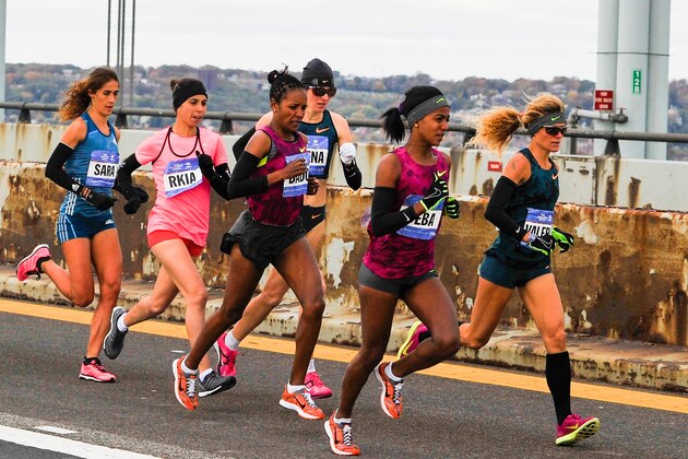 NEW YORK, NY - NOVEMBER 02:  Buzunesh Deba and Valeria Straneo lead a group as they cross the Verrazano-Narrows Bridge at the start of the TCS New York City Marathon on November 2, 2014 in the Brooklyn borough of New York City.  (Photo by Alex Goodlett/Getty Images)