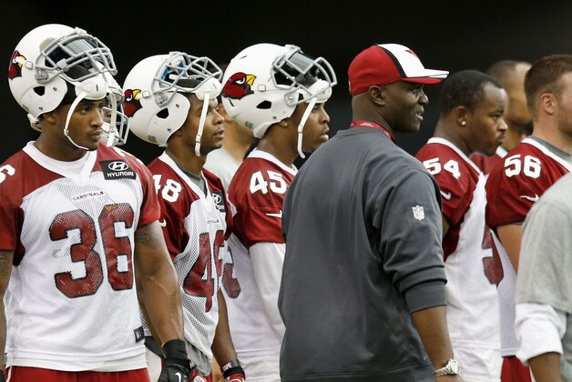 In this July 16, 2014, photo, Arizona Cardinals defensive coordinator Todd Bowles, front right, watches NFL football training camp along with defensive players Deone Bucannon (36), Trevardo Williams (48), Jonathan Brown (45), Kenny Demens (54) and Glenn Carson (56) in Glendale, Ariz. Bowles is a master strategist, although he downplays how much that factors into the team's success.
