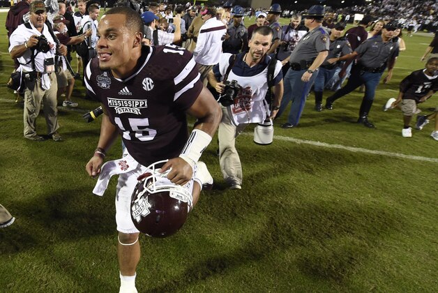 Oct 11, 2014; Starkville, MS, USA; Mississippi State Bulldogs quarterback Dak Prescott (15) runs off the field as he celebrates their 38-23 victory over the Auburn Tigers at Davis Wade Stadium. Mandatory Credit: John David Mercer-USA TODAY Sports
