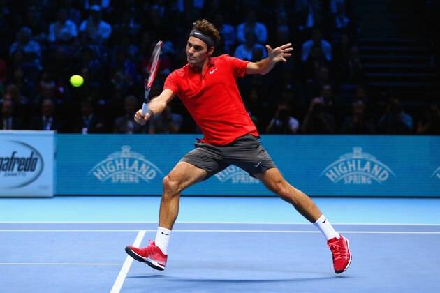LONDON, ENGLAND - NOVEMBER 13: Roger Federer of Switzerland plays a backhand in the round robin singles match against Andy Murray of Great Britain  on day five of the Barclays ATP World Tour Finals at O2 Arena on November 13, 2014 in London, England.  (Photo by Clive Brunskill/Getty Images)