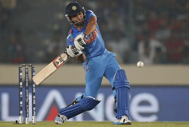 India's batsman Rohit Sharma plays a shot during their ICC Twenty20 Cricket World Cup match against Bangladesh in Dhaka, Bangladesh, Friday, March 28, 2014. (AP Photo/Aijaz Rahi)