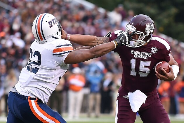 STARKVILLE, MS - NOVEMBER 08:  Dak Prescott #15 of the Mississippi State Bulldogs is pursued by Nick Brown #92 of the Tennessee Martin Skyhawks during the second quarter of a game at Davis Wade Stadium on November 8, 2014 in Starkville, Mississippi.  (Photo by Stacy Revere/Getty Images)