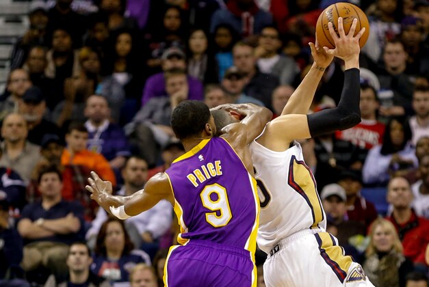 Nov 12, 2014; New Orleans, LA, USA; Los Angeles Lakers guard Ronnie Price (9) commits a flagrant 2 foul against New Orleans Pelicans guard Austin Rivers (25) during the second half of a game at the Smoothie King Center. Price was ejected from the game due to the foul. The Pelicans defeated the Lakers 109-102. Mandatory Credit: Derick E. Hingle-USA TODAY Sports