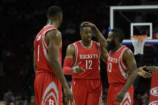 Houston Rockets' Dwight Howard (12) and James Harden (13) celebrate during an NBA basketball game against the Philadelphia 76ers, Monday, Nov. 3, 2014, in Philadelphia. (AP Photo/Matt Slocum)