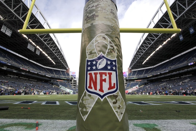 The NFL's Salute to Service logo is shown on a goalpost pad an NFL football game between the Seattle Seahawks and the New York Giants, Sunday, Nov. 9, 2014, in Seattle. Throughout the game, the Seahawks will be paying tribute to military branches and service members. (AP Photo/Elaine Thompson)
