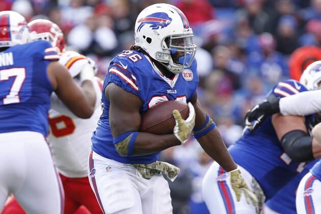 Nov 9, 2014; Orchard Park, NY, USA; Buffalo Bills running back Anthony Dixon (26) runs against the Kansas City Chiefs during the second half at Ralph Wilson Stadium. Chiefs beat the Bills 17-13. Mandatory Credit: Kevin Hoffman-USA TODAY Sports