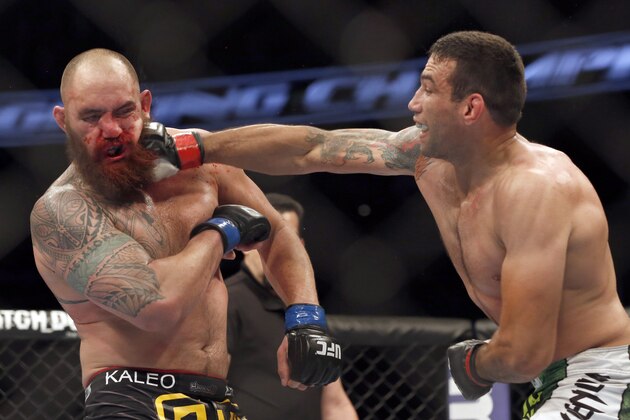 Fabricio Werdum, right, hits Travis Browne during a UFC mixed martial arts bout on Saturday, April 19, 2014, in Orlando, Fla. Werdum won. (AP Photo/Reinhold Matay)