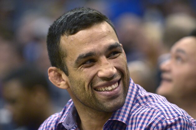 UFC mixed martial arts fighter Fabricio Werdum watches from court side seats during the second half of an NBA basketball game between the Orlando Magic and Memphis Grizzlies in Orlando, Fla., Wednesday, Feb. 12, 2014. The Grizzlies won 86-81.(AP Photo/Phelan M. Ebenhack)