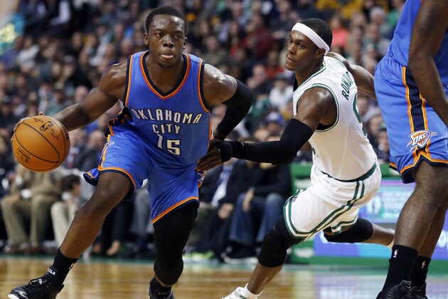 Oklahoma City Thunder guard Reggie Jackson (15) drives against Boston Celtics guard Rajon Rondo during the first half of an NBA basketball game in Boston, Wednesday, Nov. 12, 2014. (AP Photo/Elise Amendola)