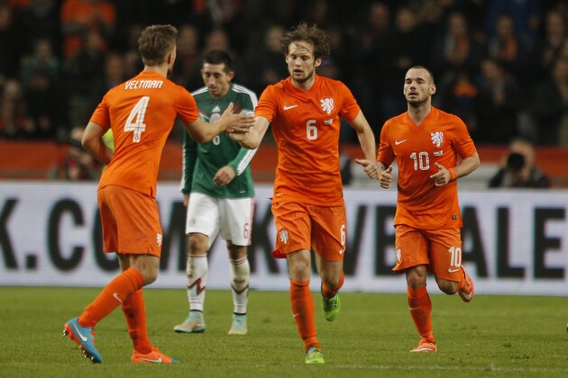 Netherlands' Daley Blind, center, celebrates with Netherlands' Joel Veltman, left, and Netherlands' Wesley Sneijder after scoring a goal during the international friendly soccer match between the Netherlands and Mexico at ArenA stadium in Amsterdam, Netherlands, Wednesday, Nov. 12, 2014. (AP Photo/Peter Dejong)