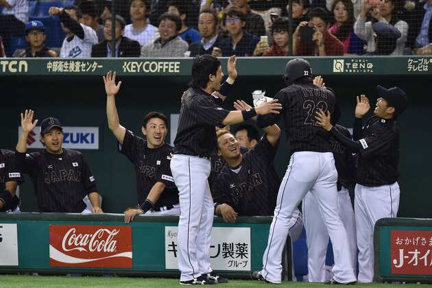 TOKYO, JAPAN - NOVEMBER 14: Hikaru Ito # 22 of Samurai Japan celebrates after scoring in the second inning during the game two of Samurai Japan and MLB All Stars at Tokyo Dome on November 14, 2014 in Tokyo, Japan.  (Photo by Atsushi Tomura/Getty Images)