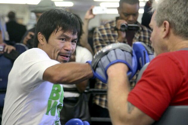 Manny Pacquiao is shown training with coach Freddie Roach Wednesday April 2, 2014 at the Wild Card Boxing Club in Los Angeles. Pacquiao is scheduled to fight Timothy Bradley April 12 in a WBO Welterweight title bout. (AP Photo/Nick Ut)