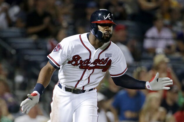 Atlanta Braves' Jason Heyward claps after hitting a single to score teammate Andrelton Simmons in the seventh inning of a baseball game against the Miami Marlins, Friday, Aug. 29, 2014, in Atlanta. (AP Photo/David Goldman)