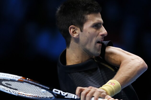 Serbia’s Novak Djokovic plays a return to Czech Republic’s Tomas Berdych, during their singles ATP World Tour Finals tennis match at the O2 Arena in London, Friday, Nov. 14, 2014. (AP Photo/Kirsty Wigglesworth)