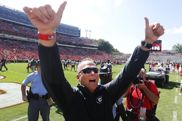 Georgia head coach Mark Richt gestures toward the crowd after defeating Troy 66-0 in an NCAA college football game, Saturday, Sept. 20, 2014, in Athens, Ga. (AP Photo/John Bazemore)