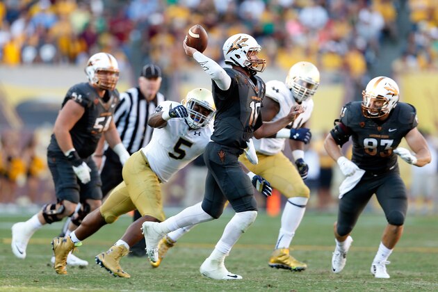 TEMPE, AZ - NOVEMBER 08:  Quarterback Taylor Kelly #10 of the Arizona State Sun Devils throws a pass under pressure from linebacker Nyles Morgan #5 of the Notre Dame Fighting Irish during the fourth quarter of the college football game at Sun Devil Stadium on November 8, 2014 in Tempe, Arizona. The Sun Devils defeated the Fighting Irish 55-31.  (Photo by Christian Petersen/Getty Images)