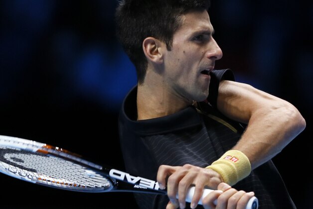 Serbia’s Novak Djokovic plays a return to Czech Republic’s Tomas Berdych, during their singles ATP World Tour Finals tennis match at the O2 Arena in London, Friday, Nov. 14, 2014. (AP Photo/Kirsty Wigglesworth)