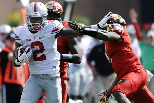 Ohio State's Dontre Wilson fights off Maryland's William Likely during the first half of an NCAA college football game in College Park, Md., Saturday, Oct. 4, 2014.(AP Photo/Gail Burton)