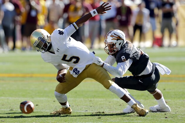 Arizona State defensive back Lloyd Carrington (8) sacks Notre Dame quarterback Everett Golson (5) during the first half of an NCAA college football game, Saturday, Nov. 8, 2014, in Tempe, Ariz. (AP Photo/Rick Scuteri)