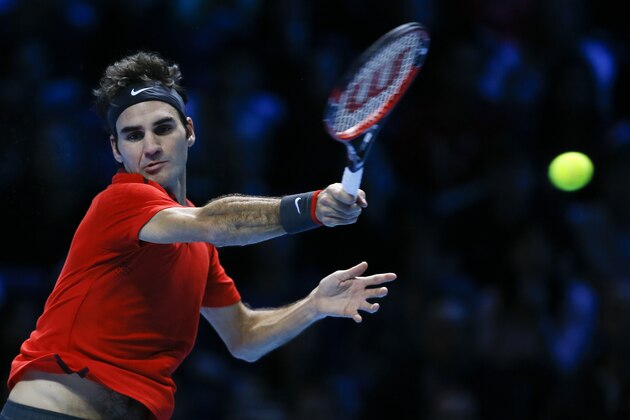 Switzerland’s Roger Federer plays a return to Britain’s Andy Murray during their singles ATP World Tour Finals tennis match at the O2 Arena in London, Thursday, Nov. 13, 2014. (AP Photo/Kirsty Wigglesworth)