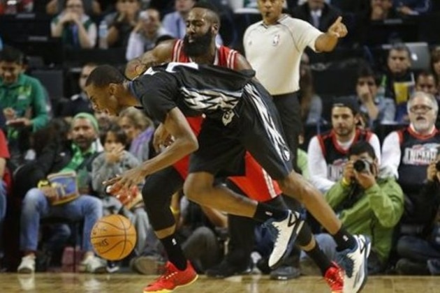 Minnesota Timberwolves' Andrew Wiggins (22) is fouled by Houston Rockets' James Harden (13) during the first half of an NBA basketball game in Mexico City, Wednesday, Nov. 12, 2014.  (AP Photo/Eduardo Verdugo)
