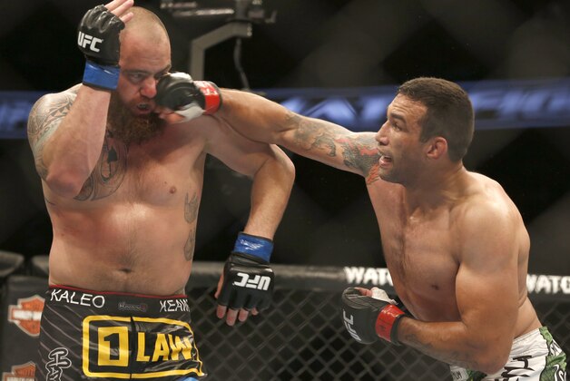 Fabricio Werdum, right, and Travis Browne fight during a UFC mixed martial arts bout on Saturday, April 19, 2014, in Orlando, Fla. Werdum won. (AP Photo/Reinhold Matay)