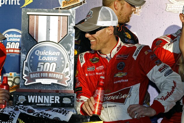 Driver Kevin Harvick celebrates in victory lane after winning the Quicken Loans Race for Heroes 500 NASCAR Sprint Cup Series auto race at Phoenix International Raceway, Sunday, Nov. 9, 2014, in Avondale, Ariz. (AP Photo/Ralph Freso)