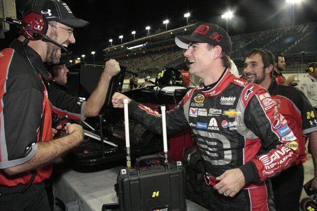 Jeff Gordon, front right, celebrates after qualifying laps for the EcoBoost 400 auto race, Friday, Nov. 14, 2014, in Homestead, Fla. Gordon won the pole position. (AP Photo/Darryl Graham)