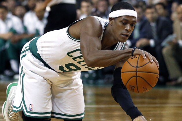 Boston Celtics guard Rajon Rondo dribbles on his knees after recovering the ball in the first half of an NBA basketball game against the Oklahoma City Thunder in Boston, Wednesday, Nov. 12, 2014. (AP Photo/Elise Amendola)
