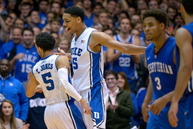 DURHAM, NC - NOVEMBER 14:  Tyus Jones #5 and Jahlil Okafor #15 of the Duke Blue Devils celebrate after Okafor's dunk against the Presbyterian Blue Hose during their game at Cameron Indoor Stadium on November 14, 2014 in Durham, North Carolina. Duke won 113-44.  (Photo by Grant Halverson/Getty Images)