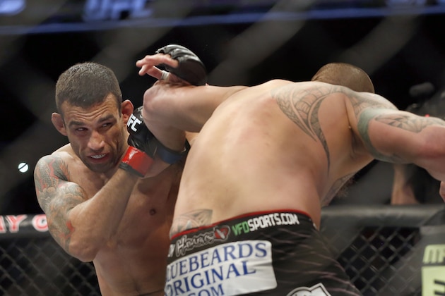 Fabricio Werdum, left, and Travis Browne fight during a UFC mixed martial arts bout on Saturday, April 19, 2014, in Orlando, Fla. Werdum won. (AP Photo/Reinhold Matay)