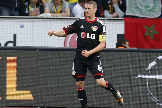 Leverkusen's Lars Bender celebrates his side's opening goal during a German Bundesliga soccer match between Bayer 04 Leverkusen and Borussia Dortmund in Leverkusen, Germany, Saturday, April 26, 2014. (AP Photo/Michael Probst)