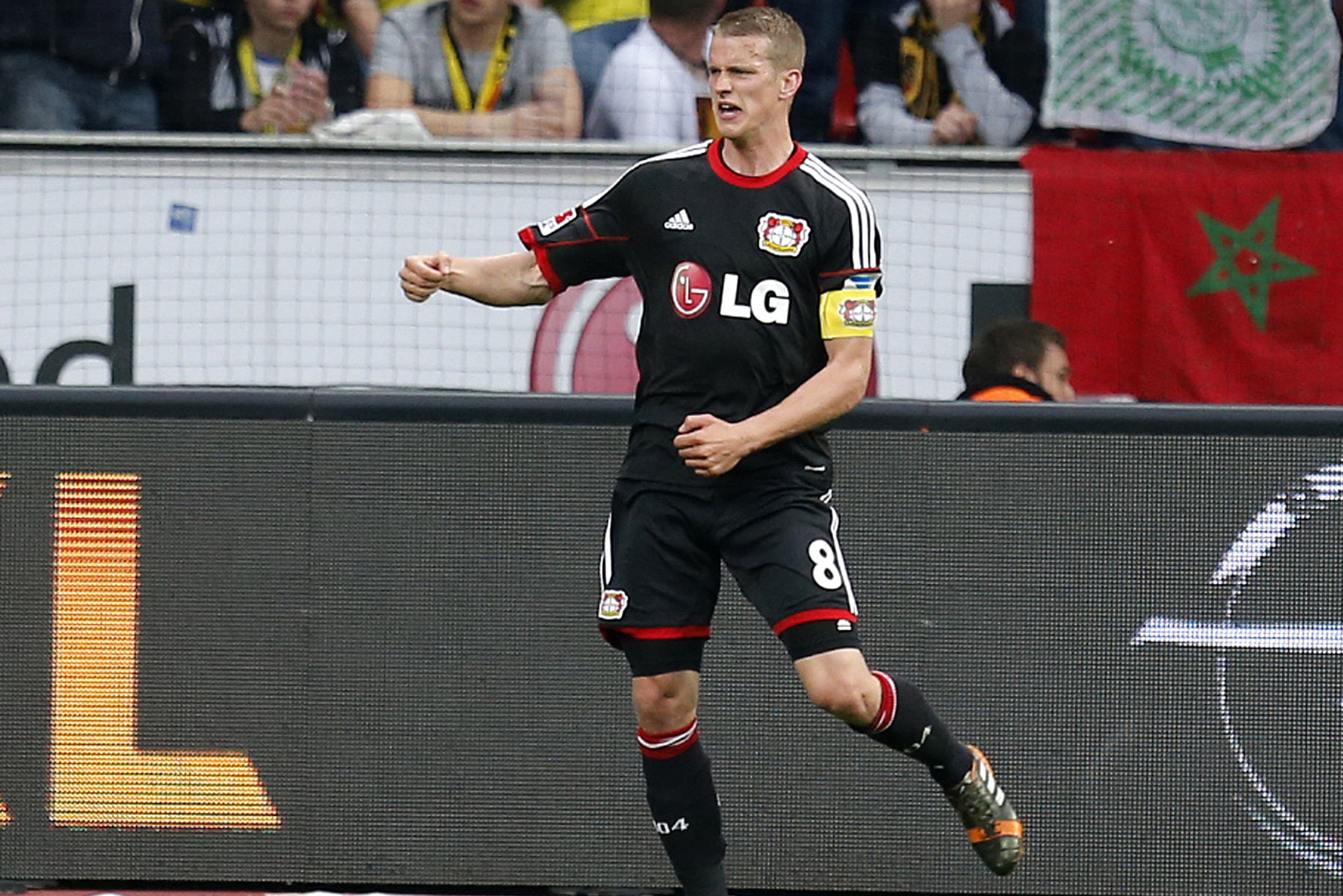 Leverkusen's Lars Bender celebrates his side's opening goal during a German Bundesliga soccer match between Bayer 04 Leverkusen and Borussia Dortmund in Leverkusen, Germany, Saturday, April 26, 2014. (AP Photo/Michael Probst)