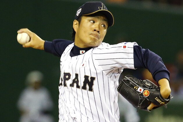 Japan's starter Takahiro Norimoto pitches against the MLB All-Stars n the first inning of Game 3 of their exhibition baseball series at Tokyo Dome in Tokyo, Saturday, Nov. 15, 2014. (AP Photo/Toru Takahashi)
