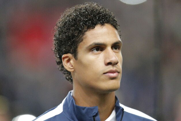 France's Raphael Varane, stands at attention during the Albanian National anthem prior to the start of a friendly soccer match France against Albania at Route de Lorient stadium in Rennes, western France, Friday, Nov. 14, 2014. The match ended in a 1-1 draw. (AP Photo/Michel Euler)